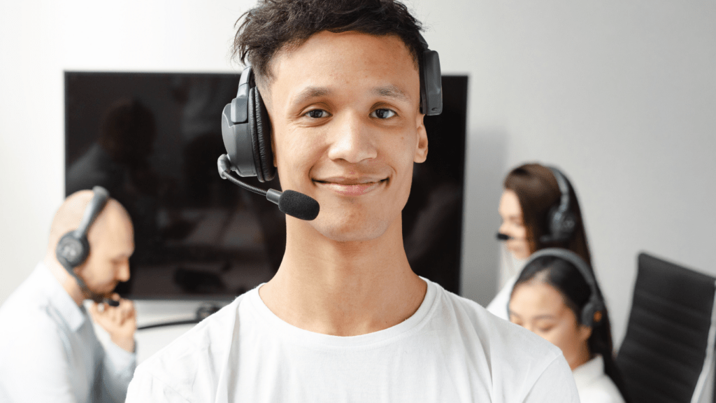 A man wearing a headset in front of a group of people