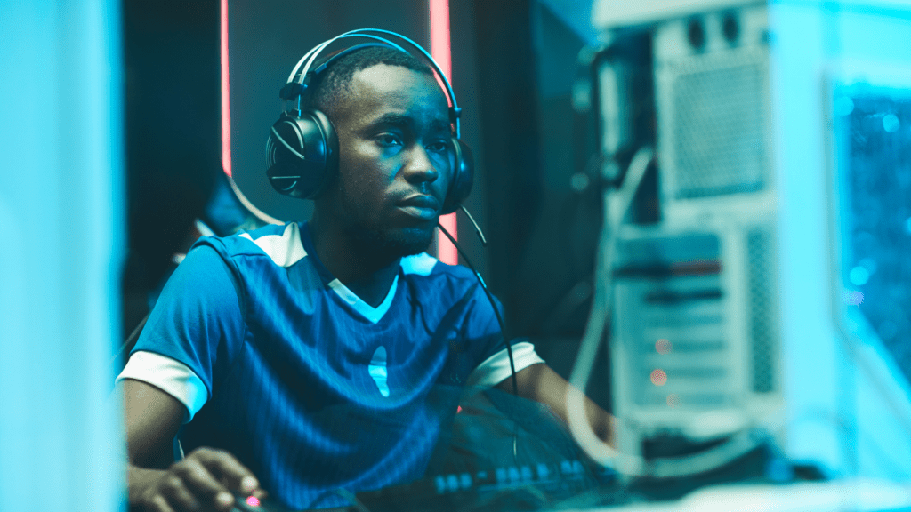 A man wearing headphones in front of a computer screen