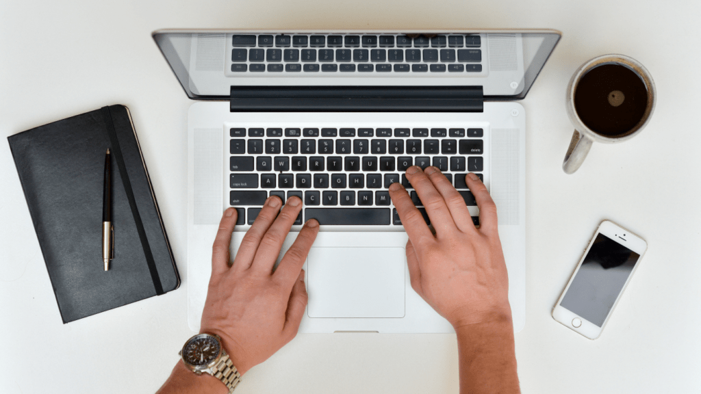 a person typing on a laptop computer