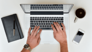 a person typing on a laptop computer