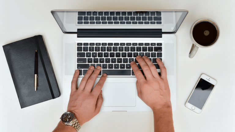 a person typing on a laptop computer