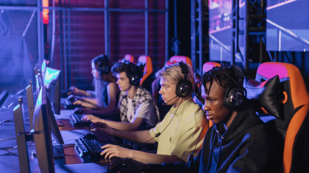 a group of people playing video games in a dark room