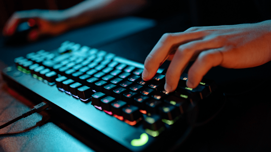 a person is typing on a laptop computer