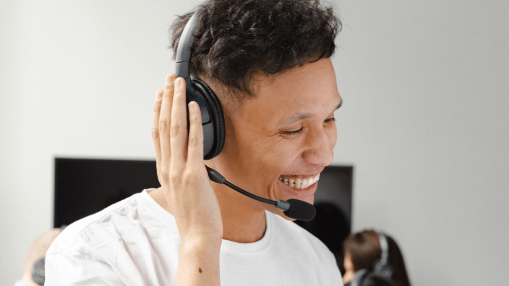 A man wearing a headset in front of a group of people