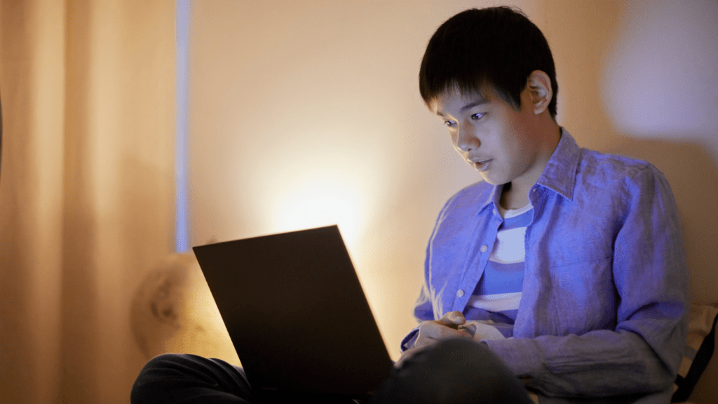 children sitting on a couch with a laptop