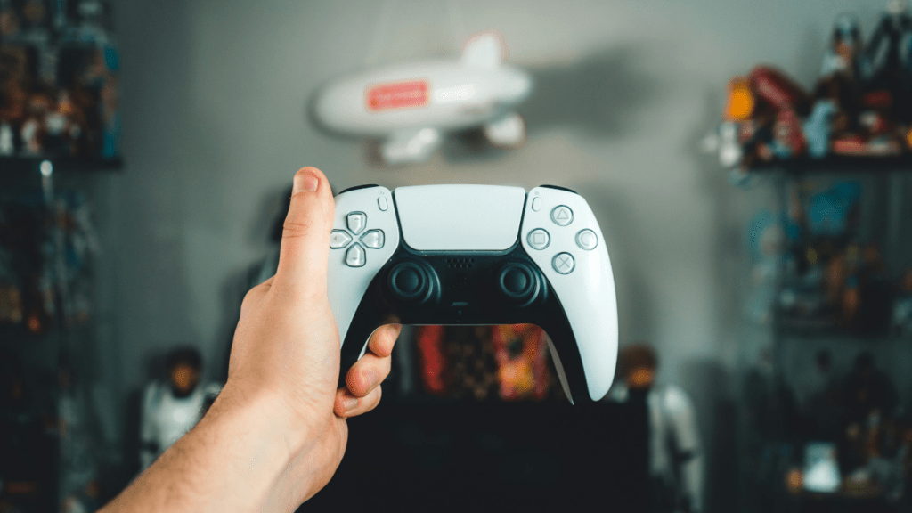 a close up of someone's hands holding a video game controller