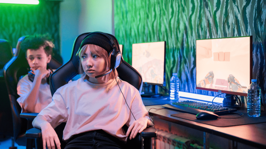 A person wearing headphones is playing a video game on a computer