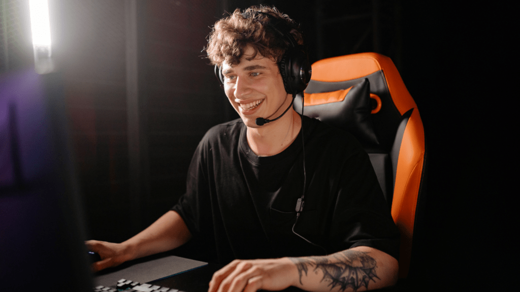 A man wearing headphones in front of a computer screen