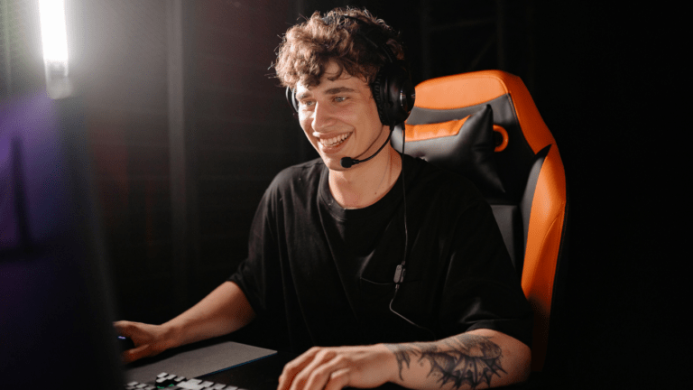 A man wearing headphones in front of a computer screen