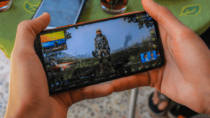 a person holding a cell phone with a game on it