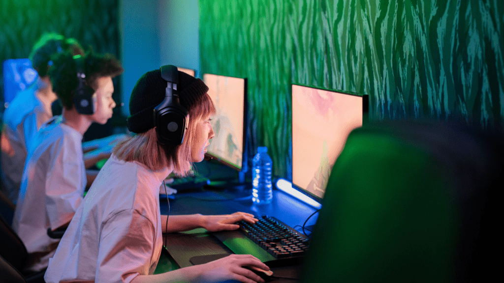 a person is sitting at a computer with a headset on