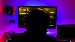 a person is typing on a keyboard in a dark room