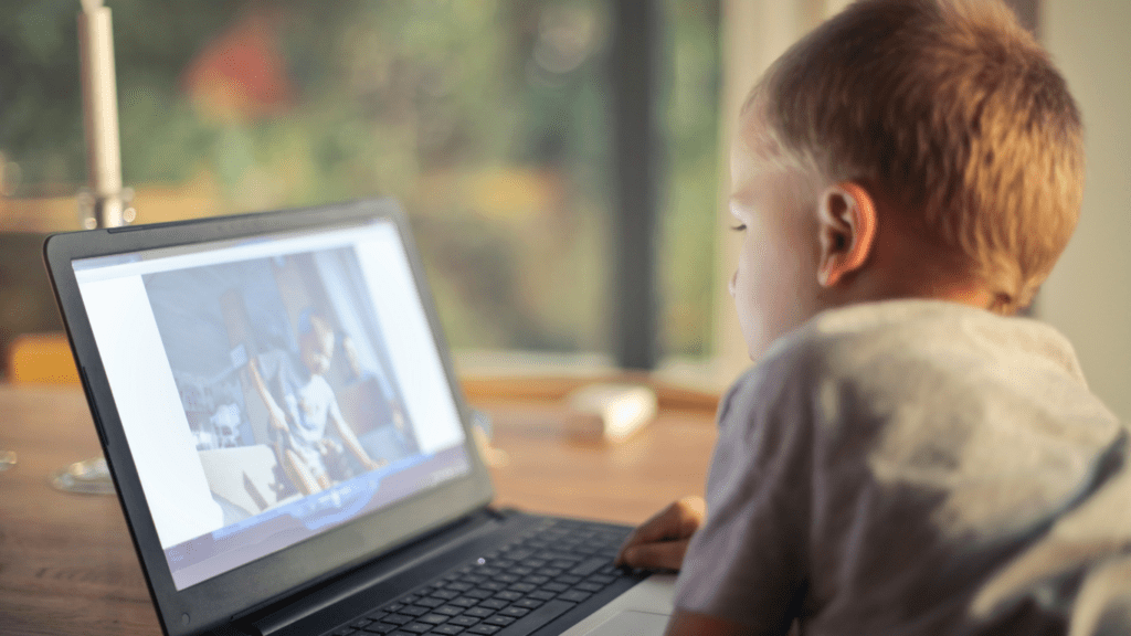 a child playing at the laptop