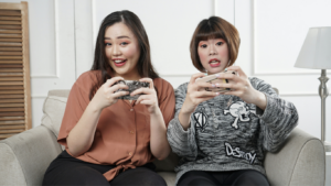 people sitting on a couch playing video games