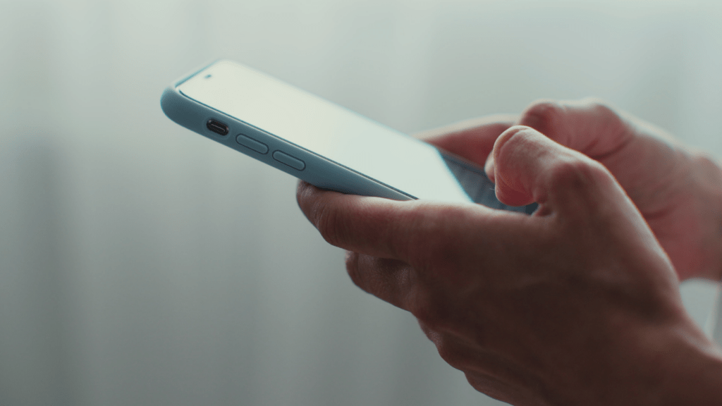 close up of a hand holding a cell phone