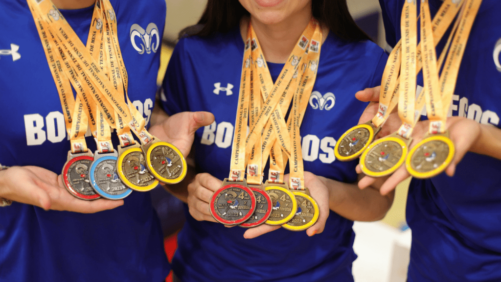 a person with a gold medal in their hand