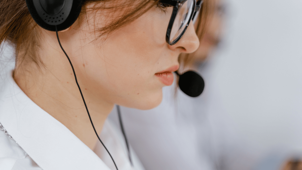 a person wearing a headset while working on their laptop