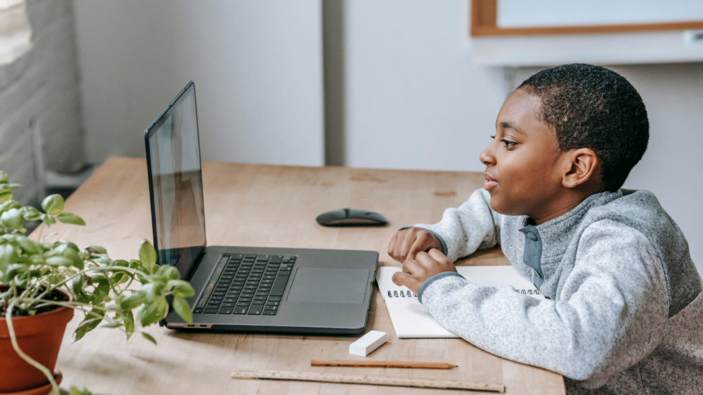 a child playing at the laptop