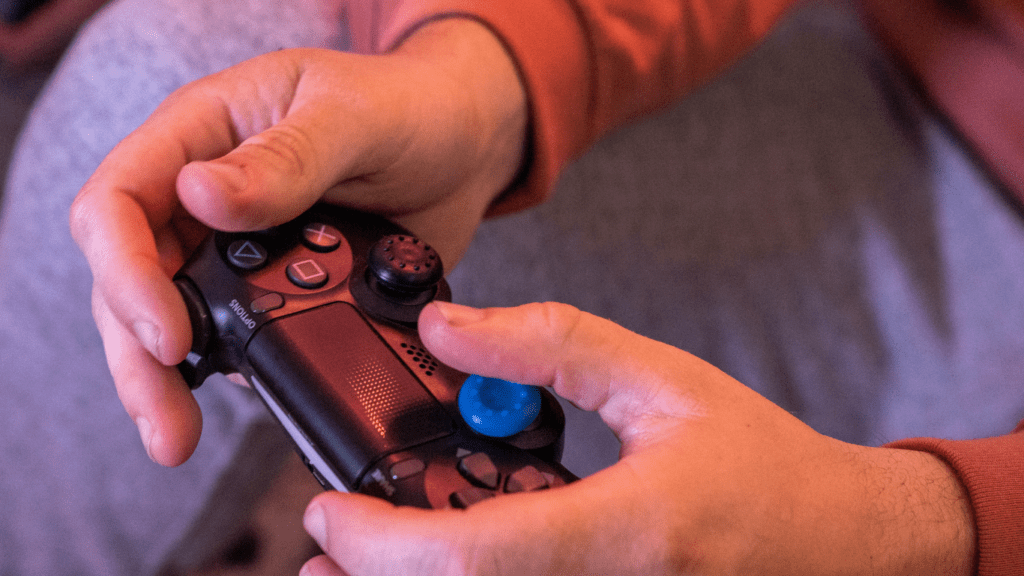 a close up of a person holding a video game controller