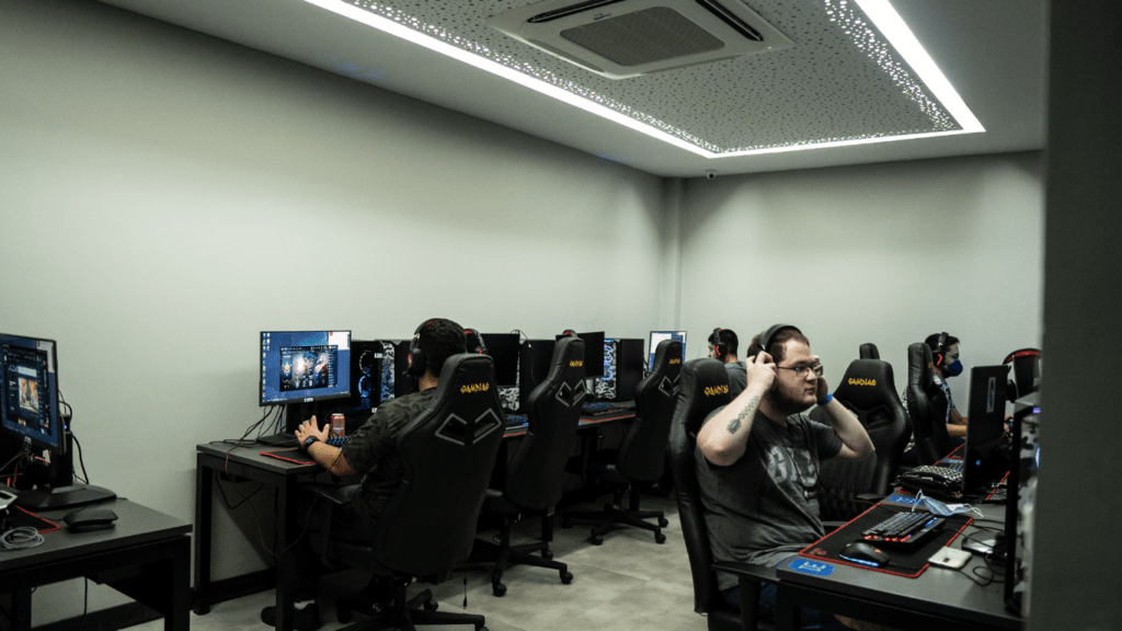 a group of people playing pc games