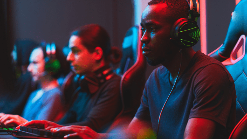 a group of people playing video games in a dark room