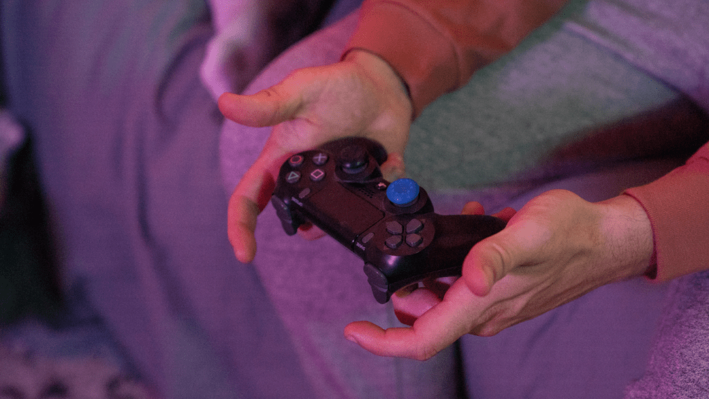 a person holding a video games controller