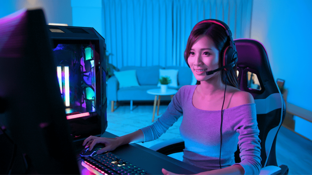 a person is sitting at a computer with a headset on