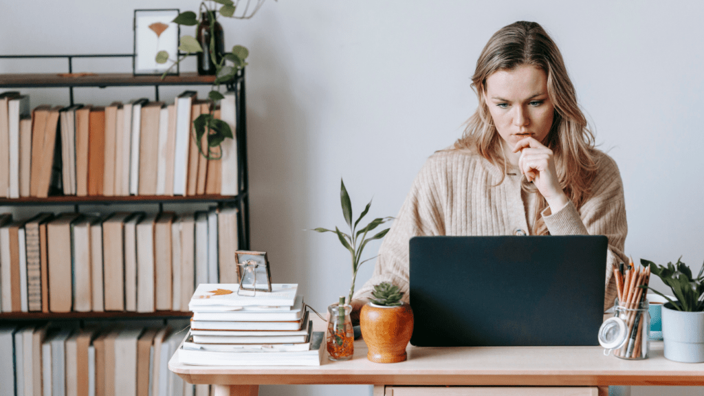 a person sitting at a desk with a laptop