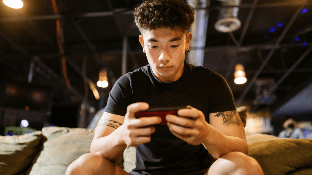 a person sitting on a couch playing a video game