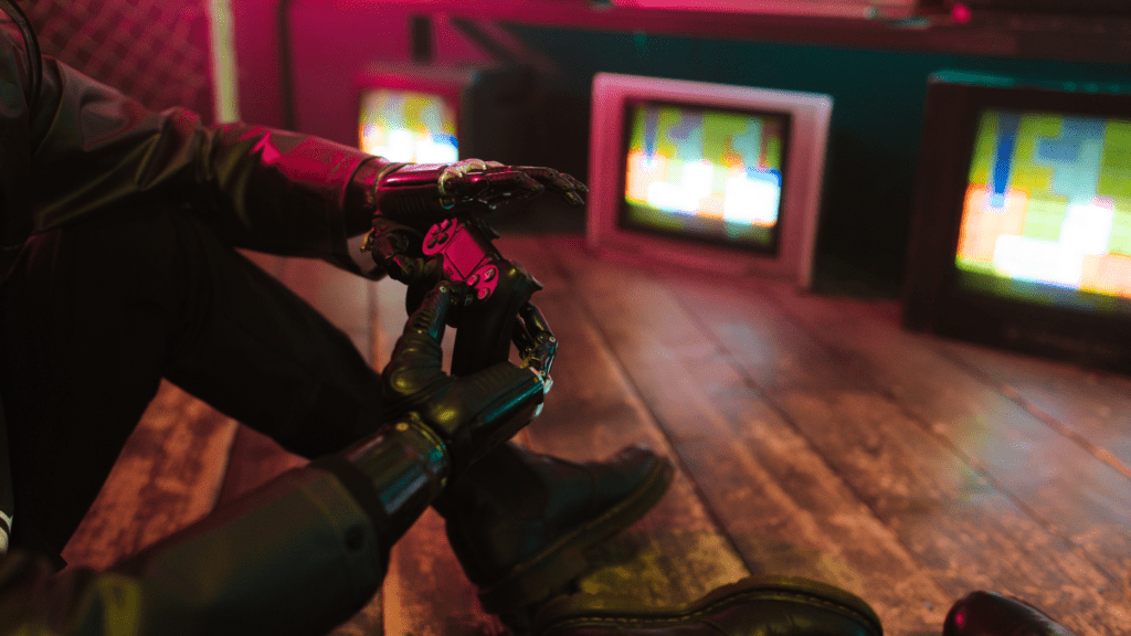 a person sitting on a wooden floor next to several televisions