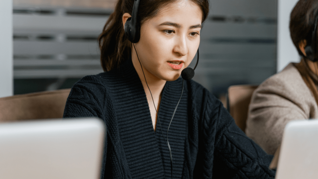 a person wearing a headset while working on their laptop