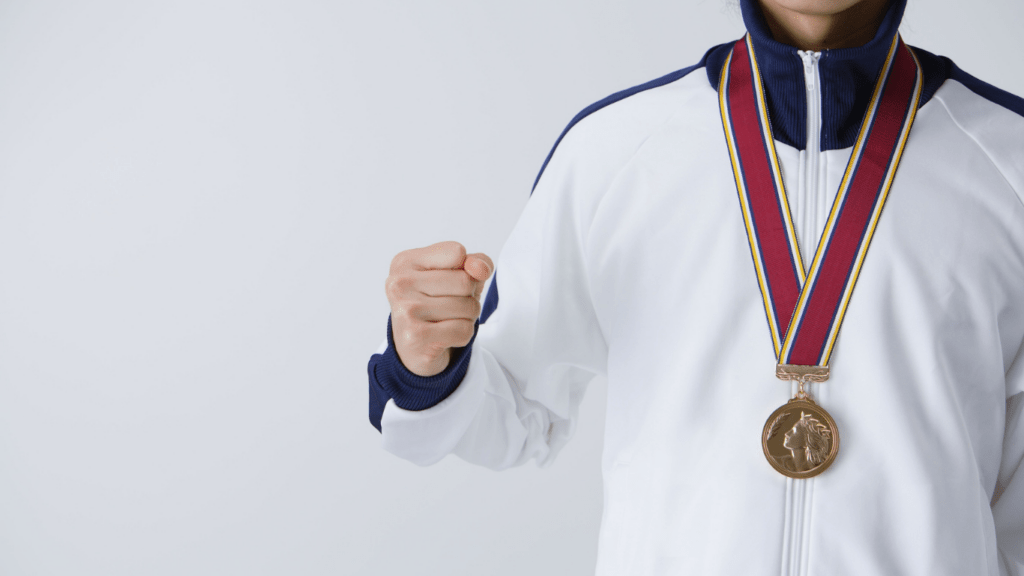 a person with a gold medal in their hand