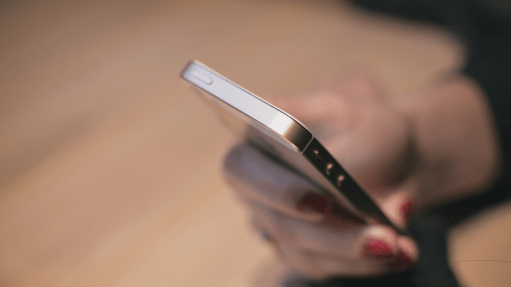 close up of a hand holding a cell phone