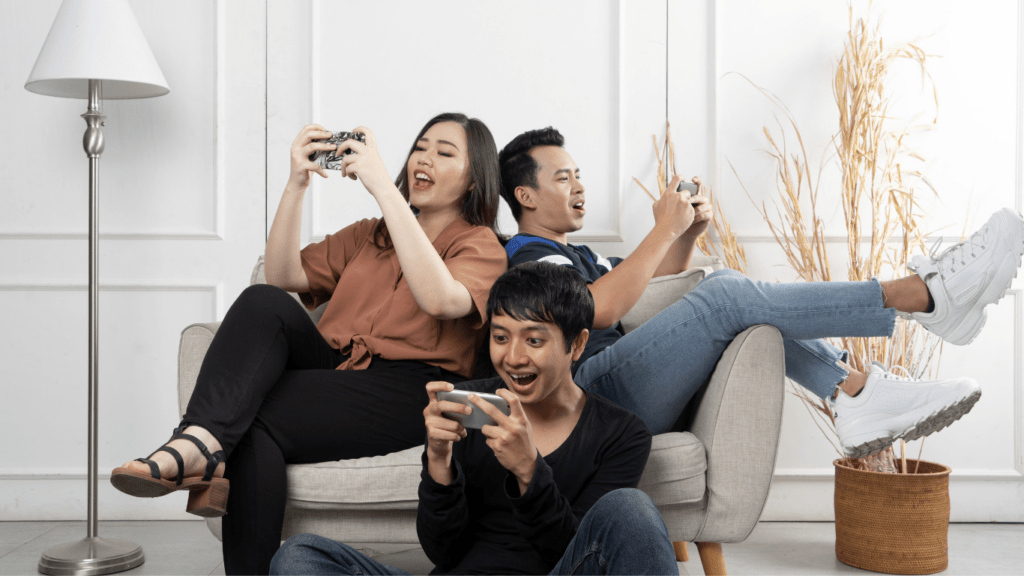 _people sitting on a couch playing video games