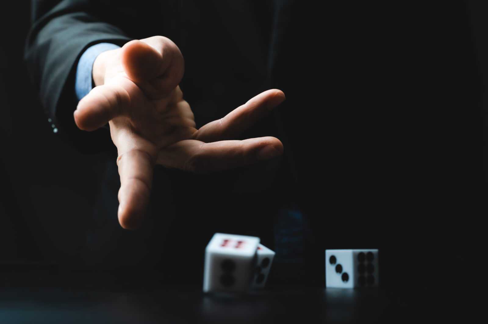 business person hand throw the dice, business gambling game concept